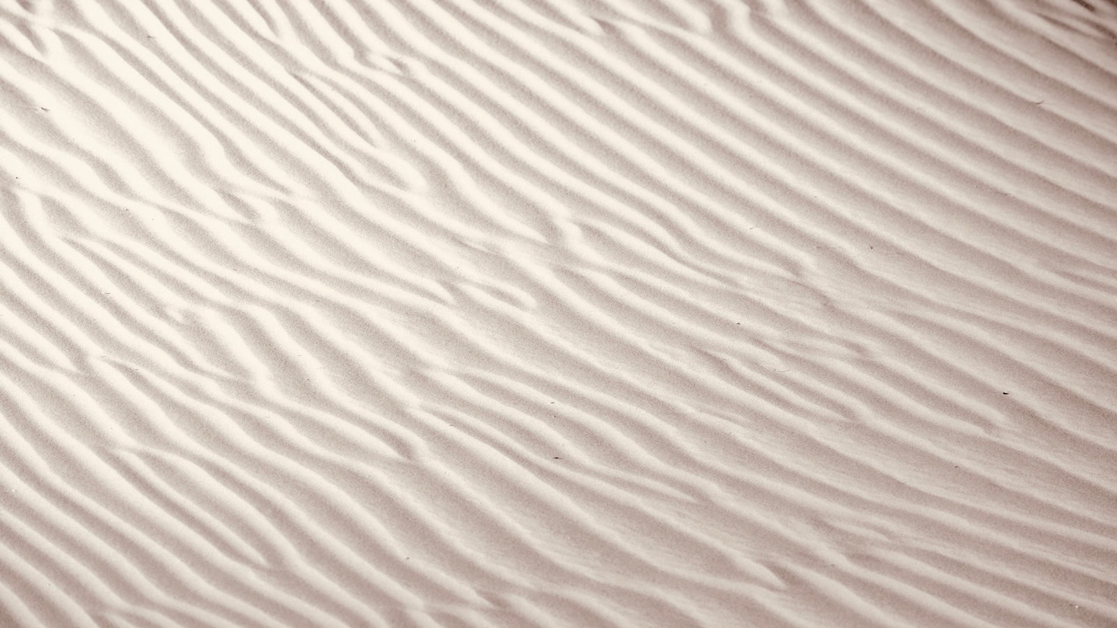 Détail texture sable et serviette Boané sur la plage